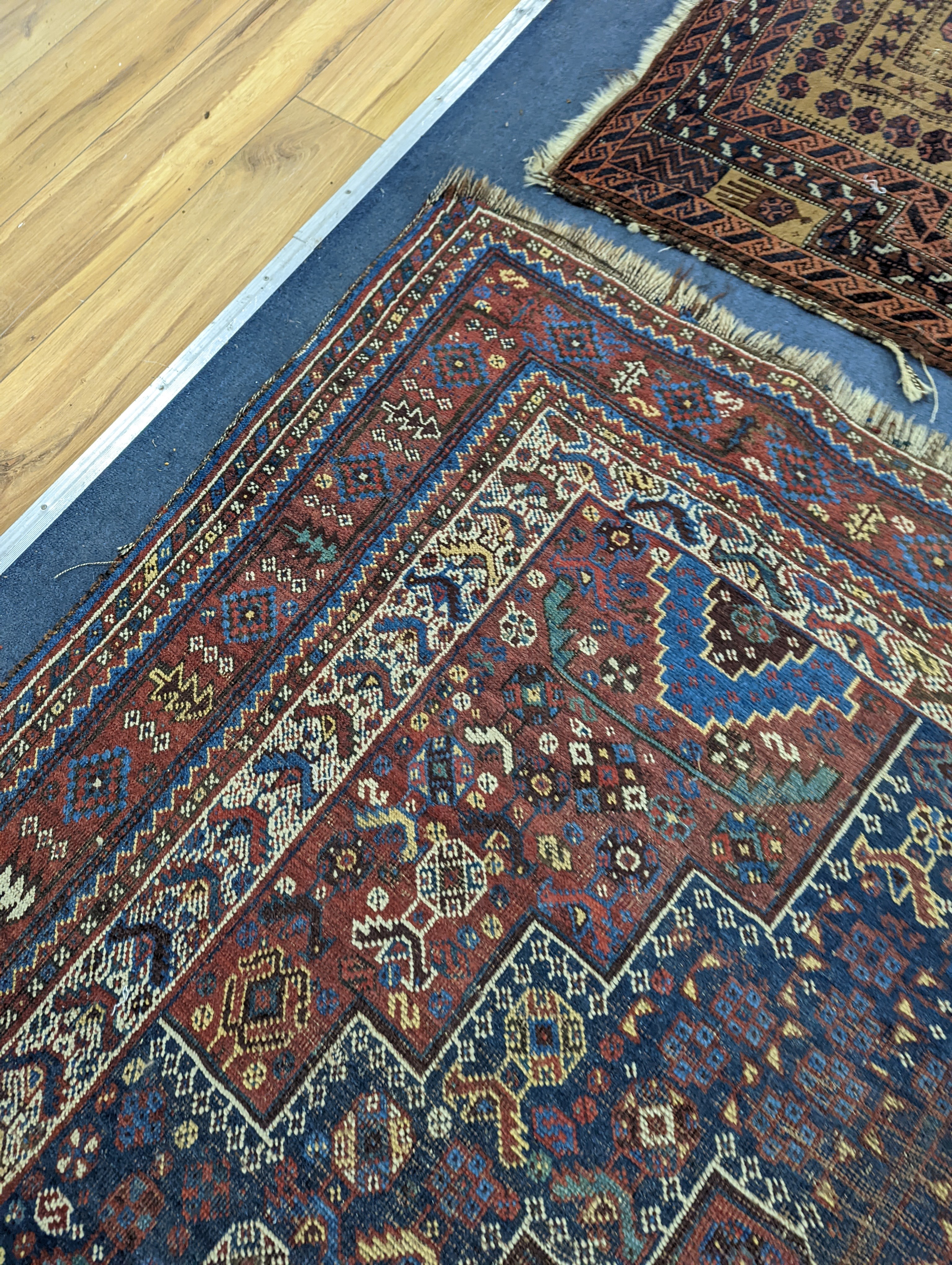A Caucasian red ground rug and a Belouch rug, larger 200 x 165cm